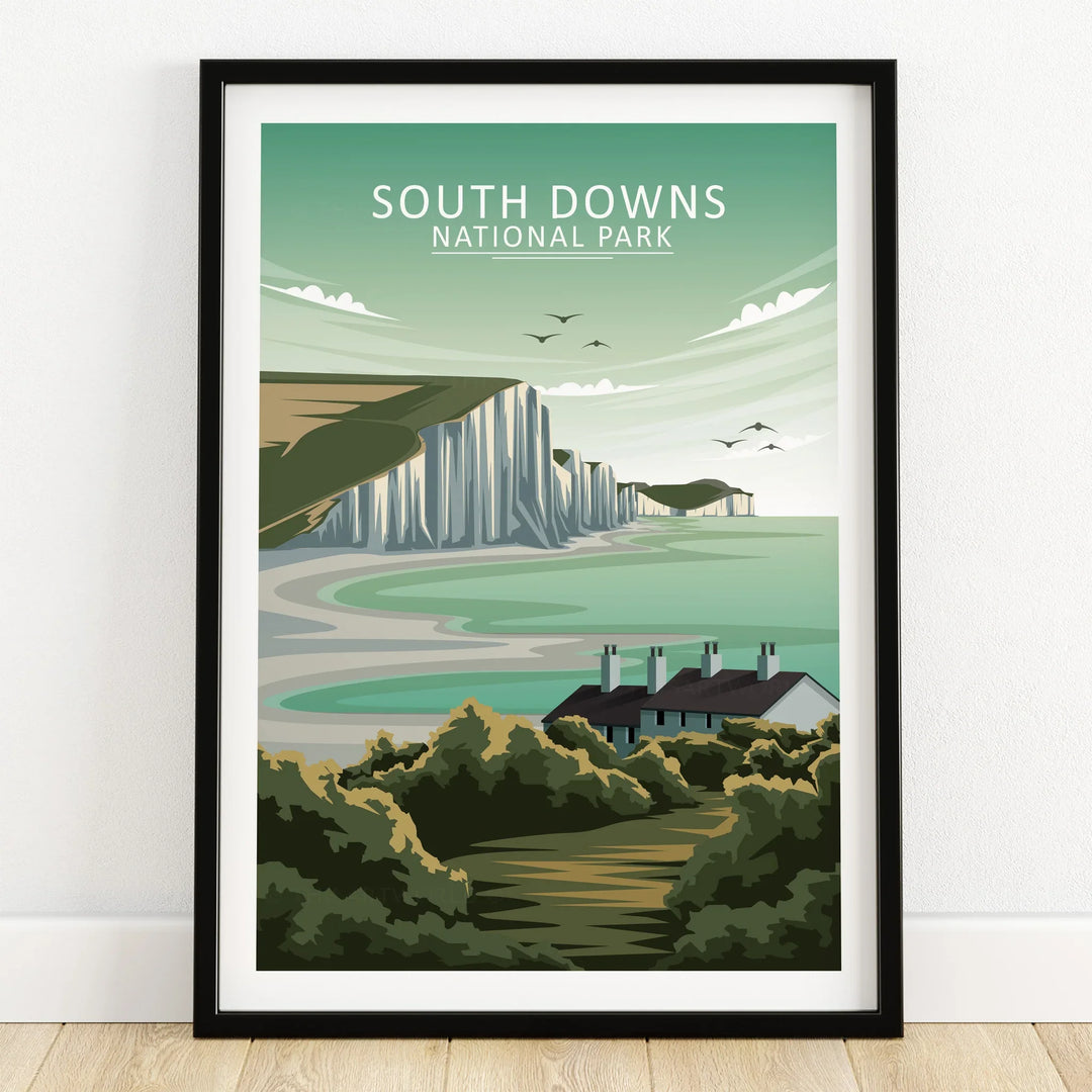 South Downs National Park art print with white cliffs, sea, and cottages in a black frame