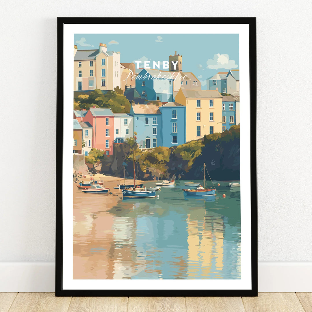 Tenby Pembrokeshire travel poster art print in black frame, colorful houses, boats on water.