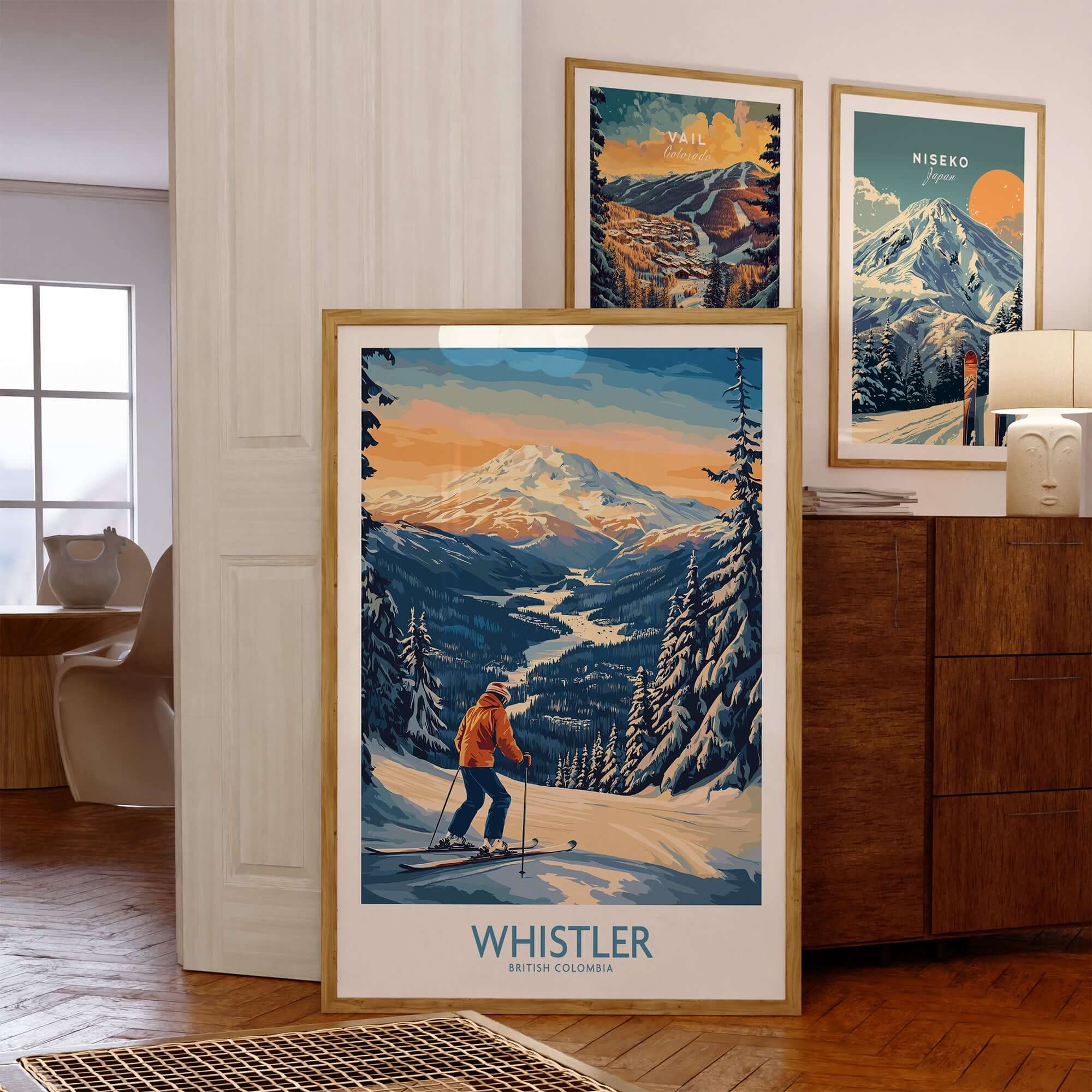 Vintage Whistler skiing poster displayed in a cozy room with other mountain art prints.