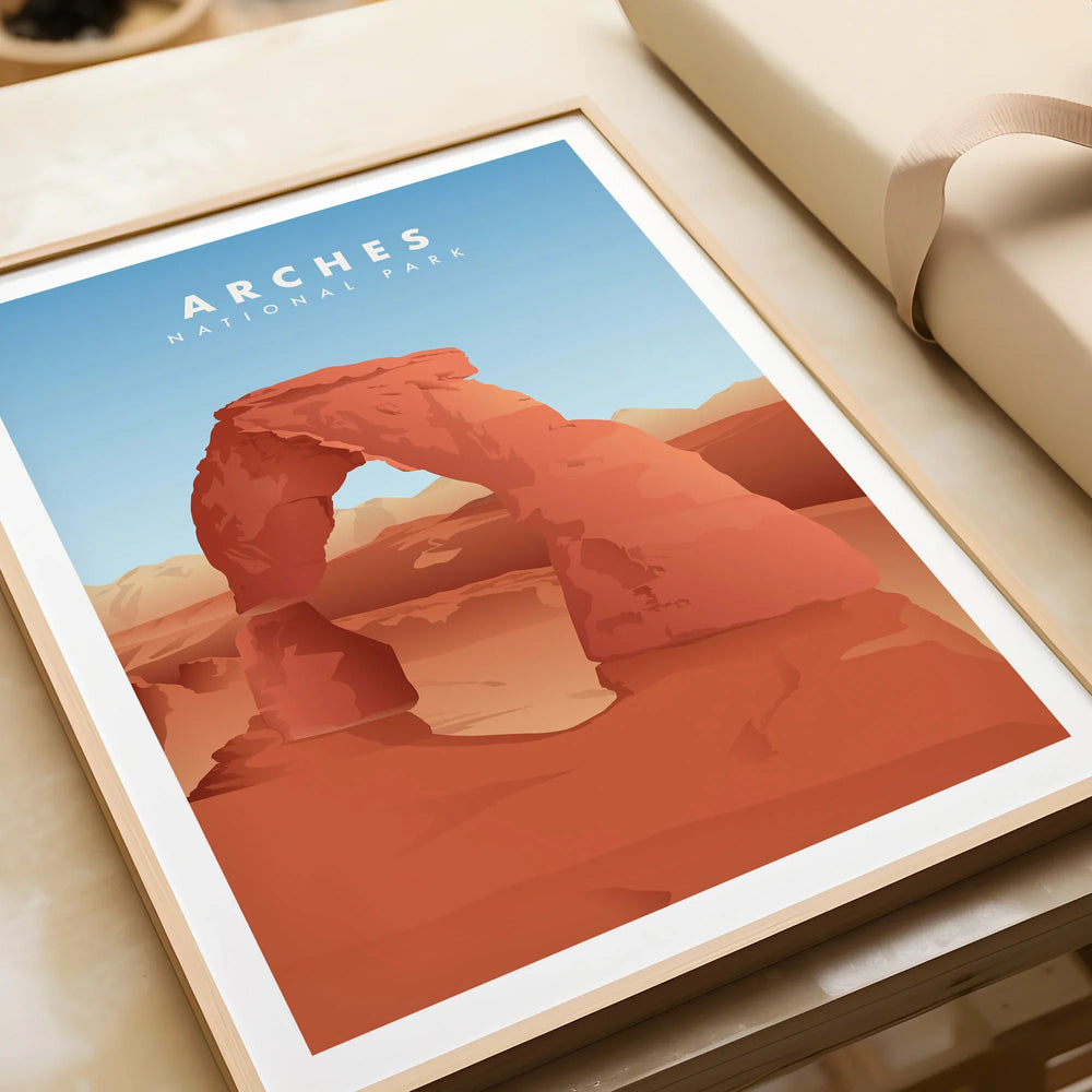 Framed Arches National Park print with Delicate Arch illustration, unwrapped on table