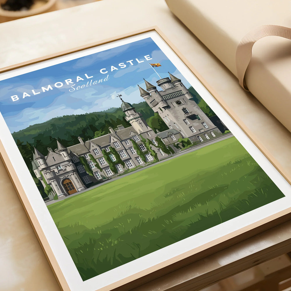 Framed art print of Balmoral Castle Scotland travel poster on table, unwrapped gift