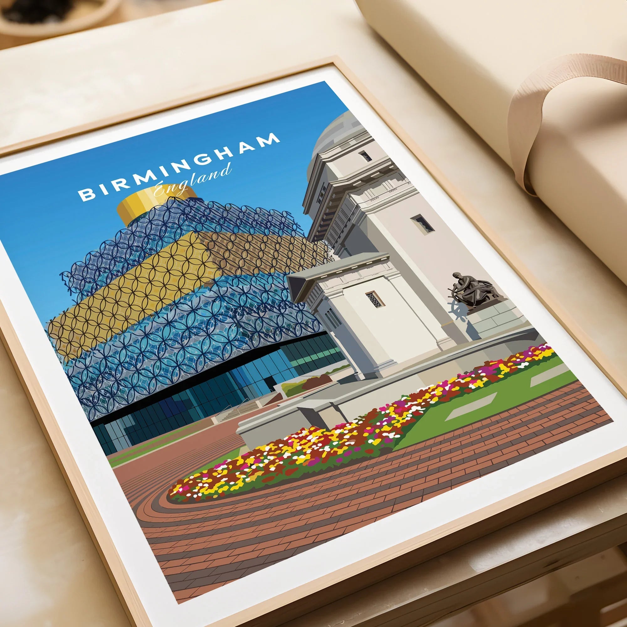 Framed Birmingham art print featuring city architecture and colorful flowers, unwrapped gift.