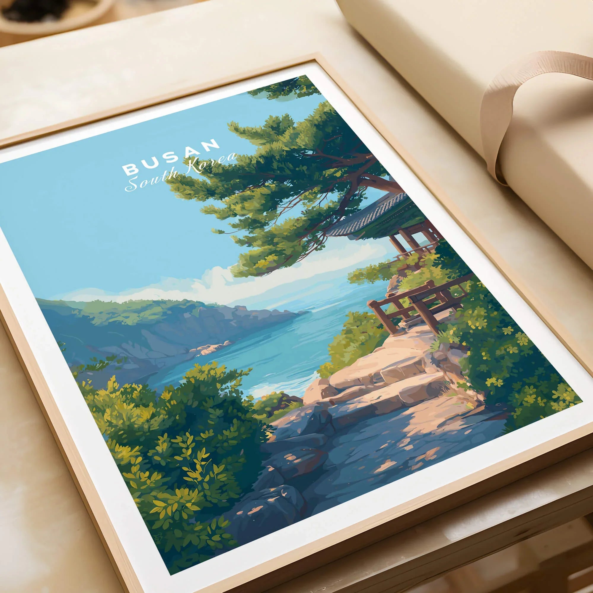 Framed Busan South Korea travel art print with coastal landscape, partially unwrapped