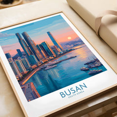 Framed Busan South Korea skyline art print with colorful sunset, modern buildings, and marina.