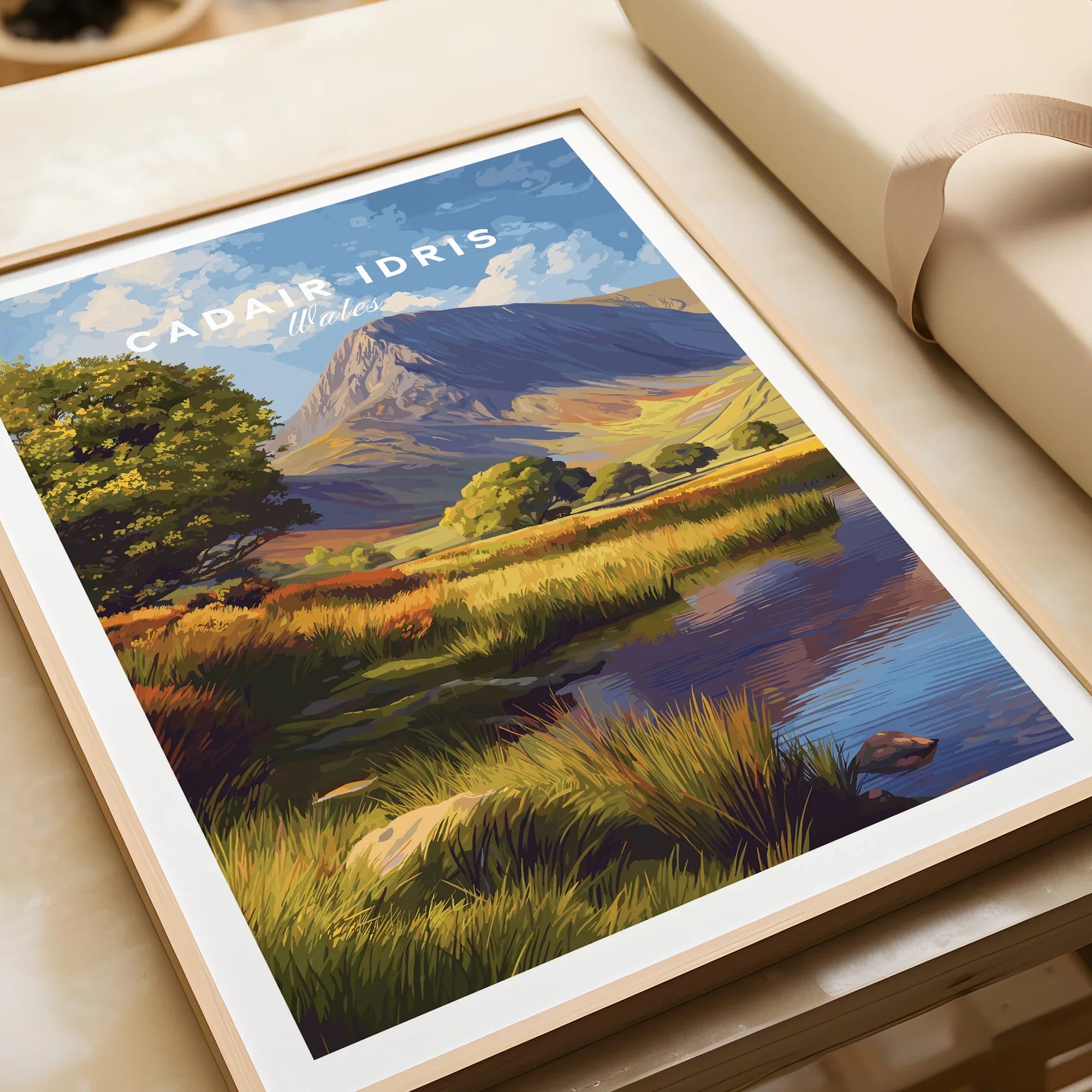 Framed art print of Cadair Idris mountain landscape with lake and grassy fields, unwrapped gift