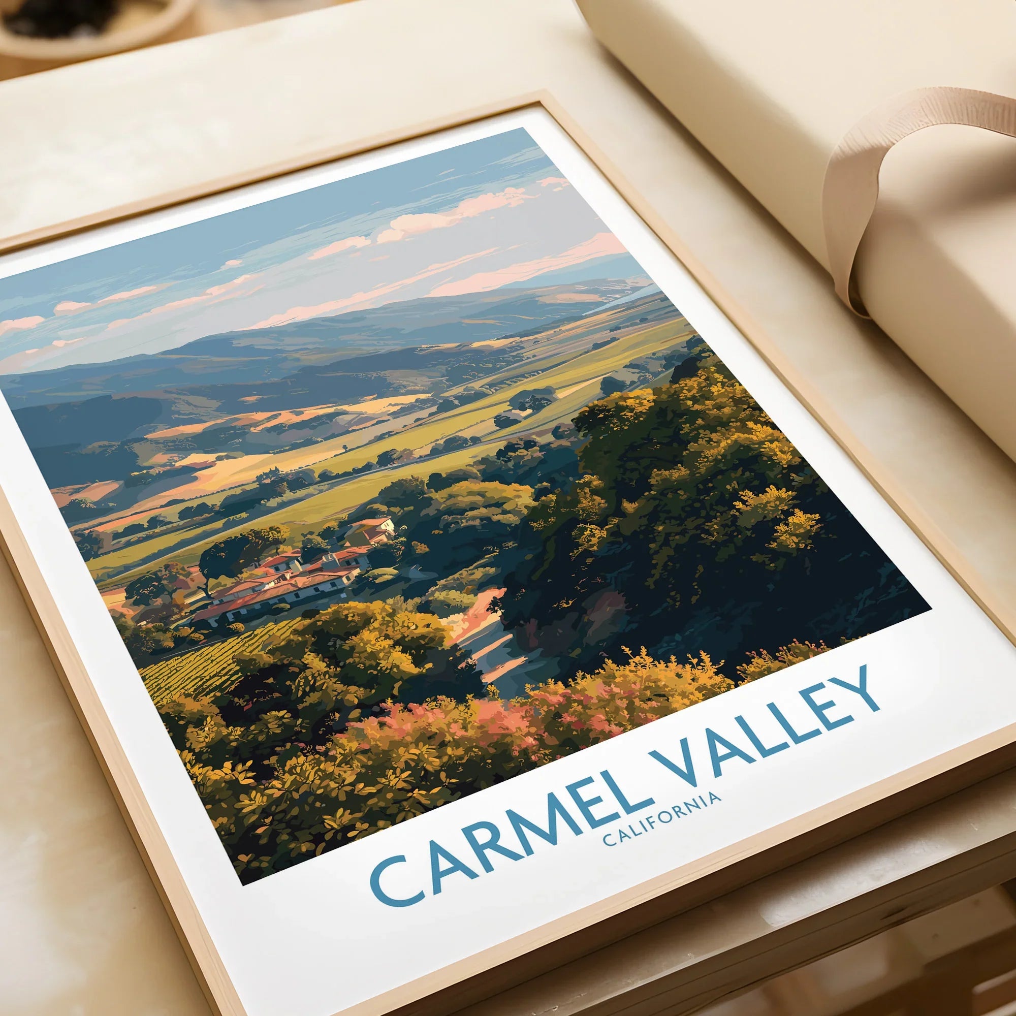 Carmel Valley California travel poster art print with natural wood frame, unwrapped on table
