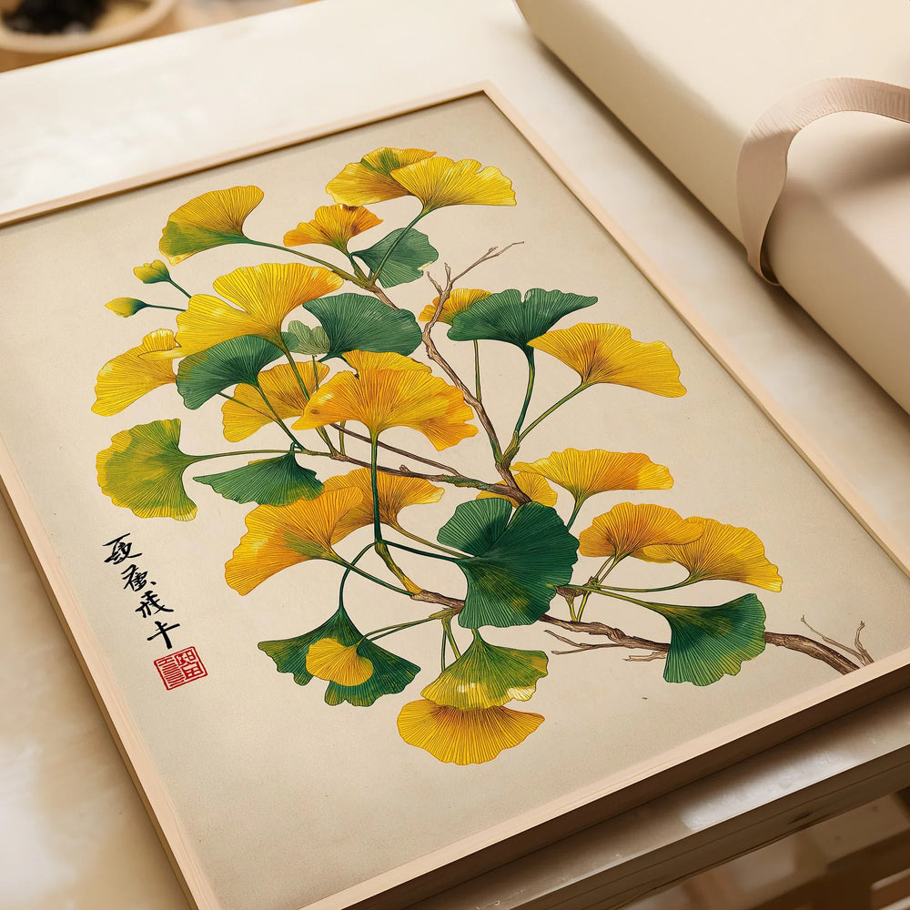 Framed art print of ginkgo tree leaves in green and yellow, unwrapped, on a light background