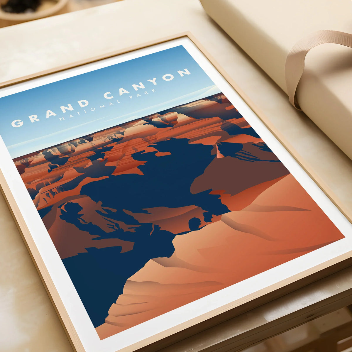 Framed Grand Canyon National Park art print with bold canyon colors on a table, unwrapped