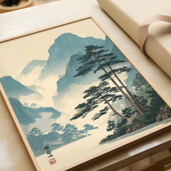 Framed Japanese woodblock art print with pine trees and misty mountains, unwrapped gift.