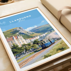 Framed Llandudno Wales travel poster print featuring vintage tram, seaside, and hills