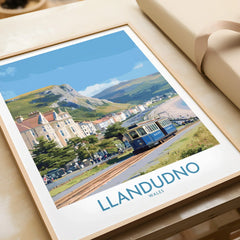 Framed Llandudno Wales travel art print with tram, coastal town, and scenic hills.
