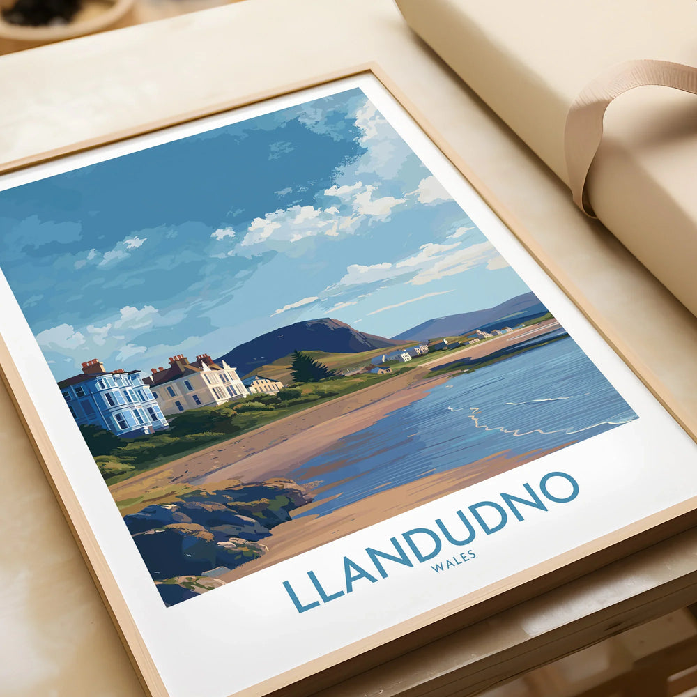 Framed Llandudno Wales travel poster with coastal landscape, unwrapped as a gift.