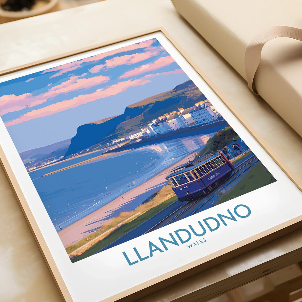 Framed Llandudno Wales travel poster print with coastal scenery and vintage tram, unwrapped as a gift.