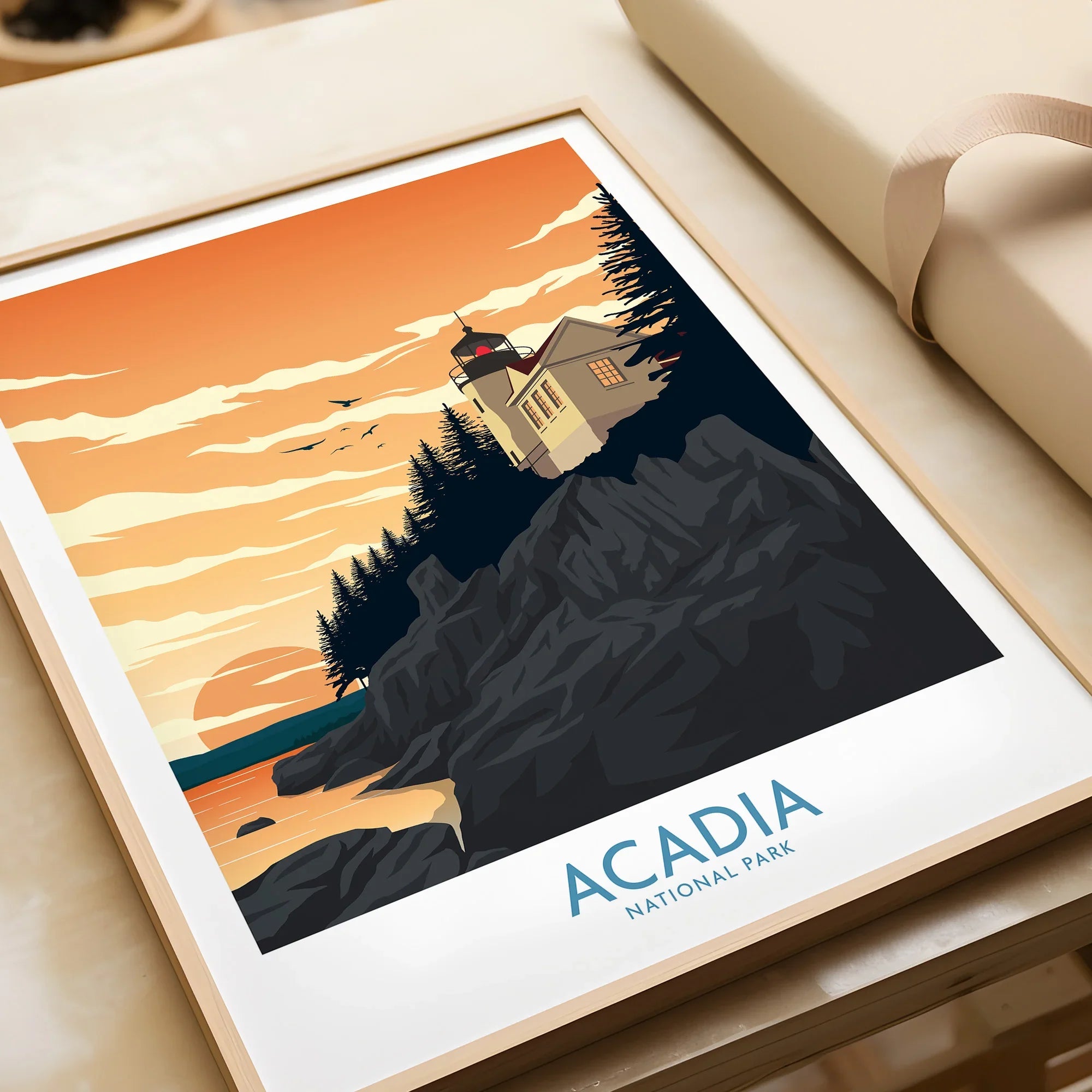 Framed Acadia National Park art print featuring a lighthouse at sunset on rocky cliffs.