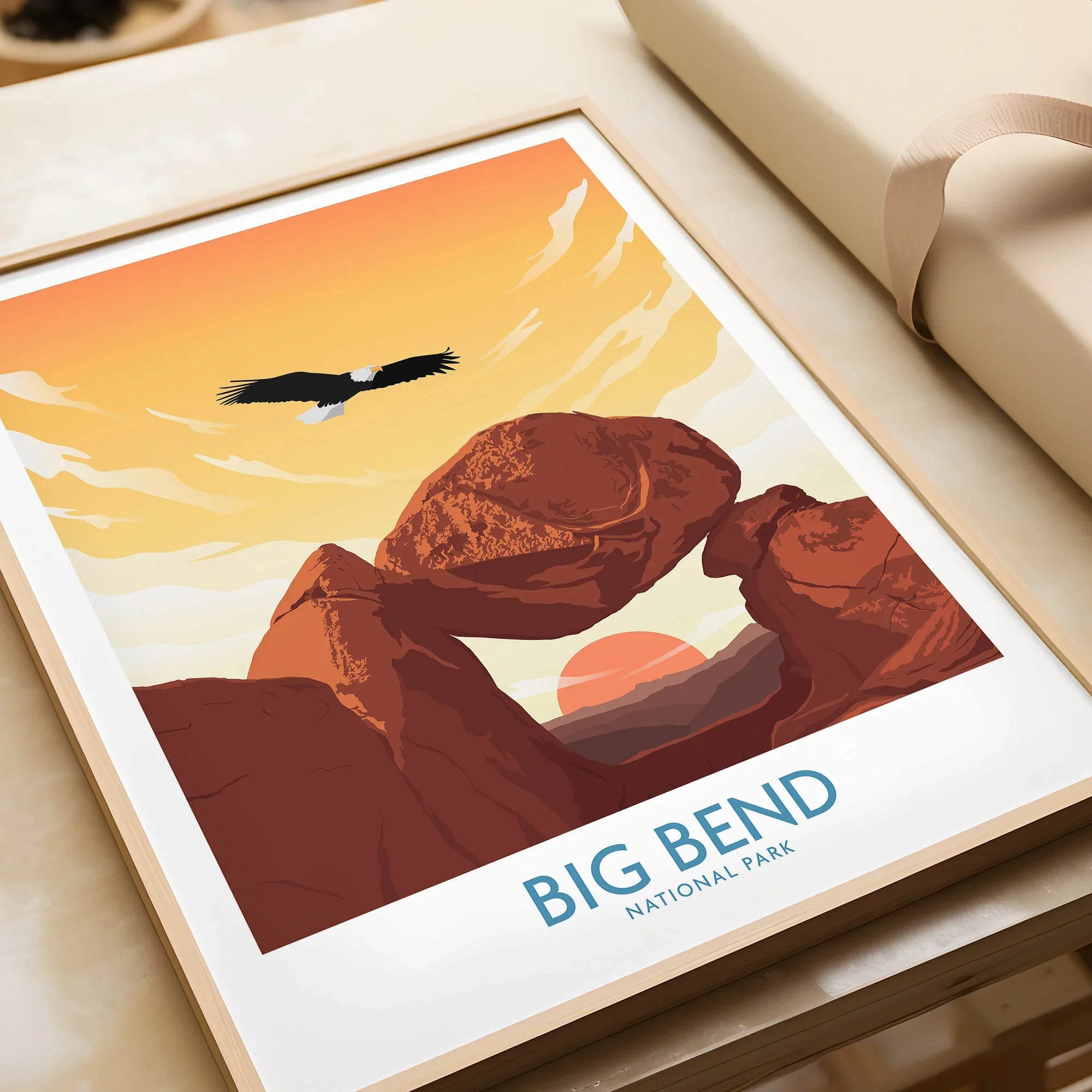 Big Bend National Park framed art print with desert rocks, sunset, and eagle, unwrapped on table