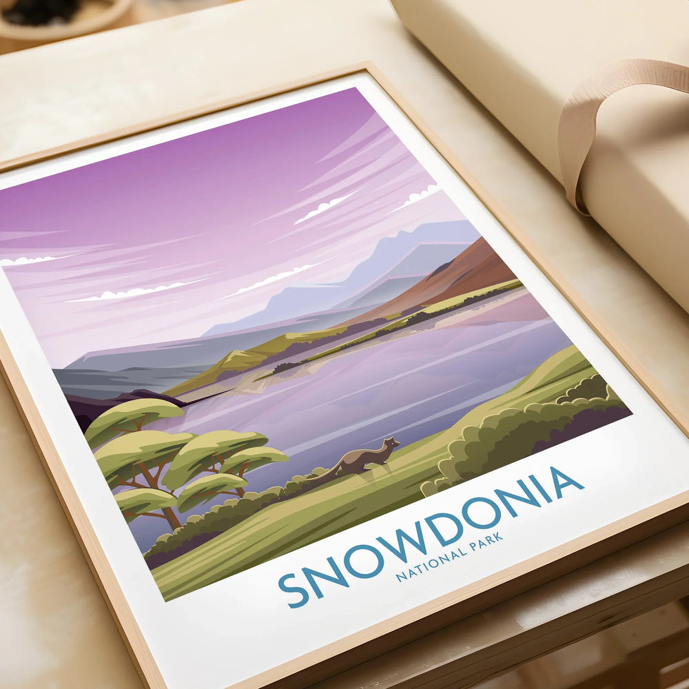 Framed Snowdonia National Park art print with scenic landscape and purple sky on gift table