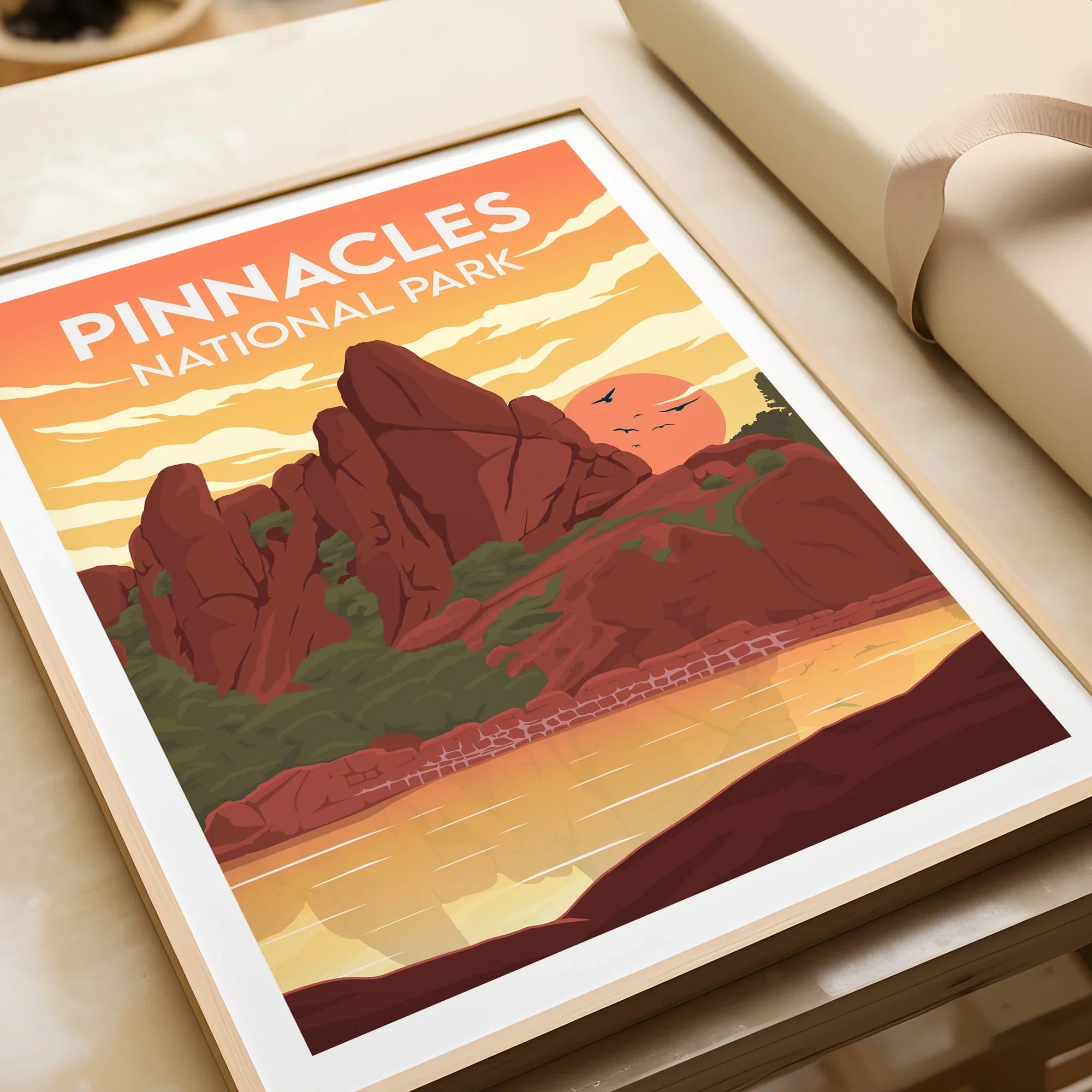 Framed Pinnacles National Park art print with vivid sunset landscape, unwrapped on table