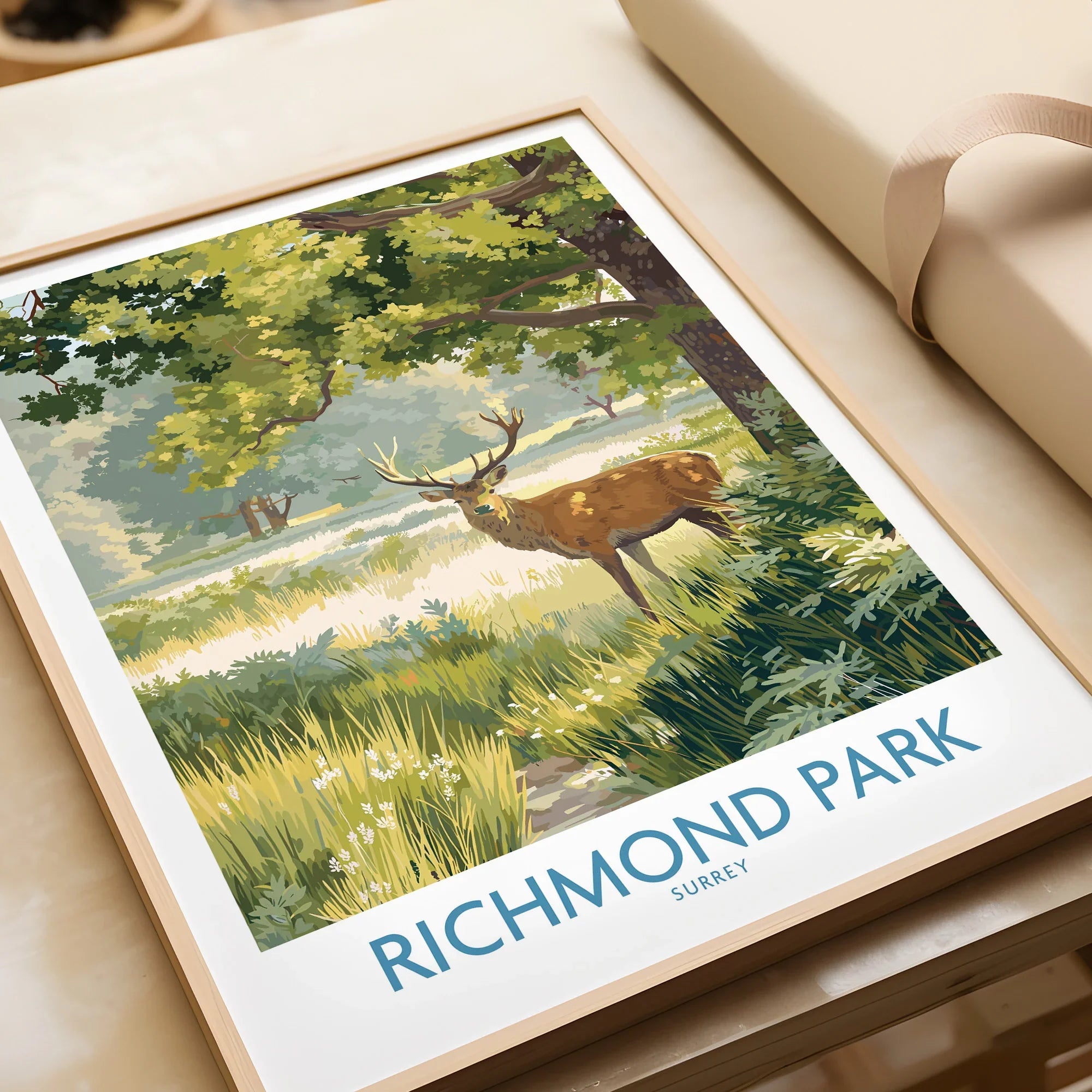 Framed Richmond Park art print featuring a deer in sunlit greenery, unwrapped as a gift.