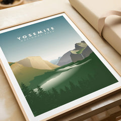 Framed Yosemite National Park art print with mountain landscape and forest, unwrapped on a table