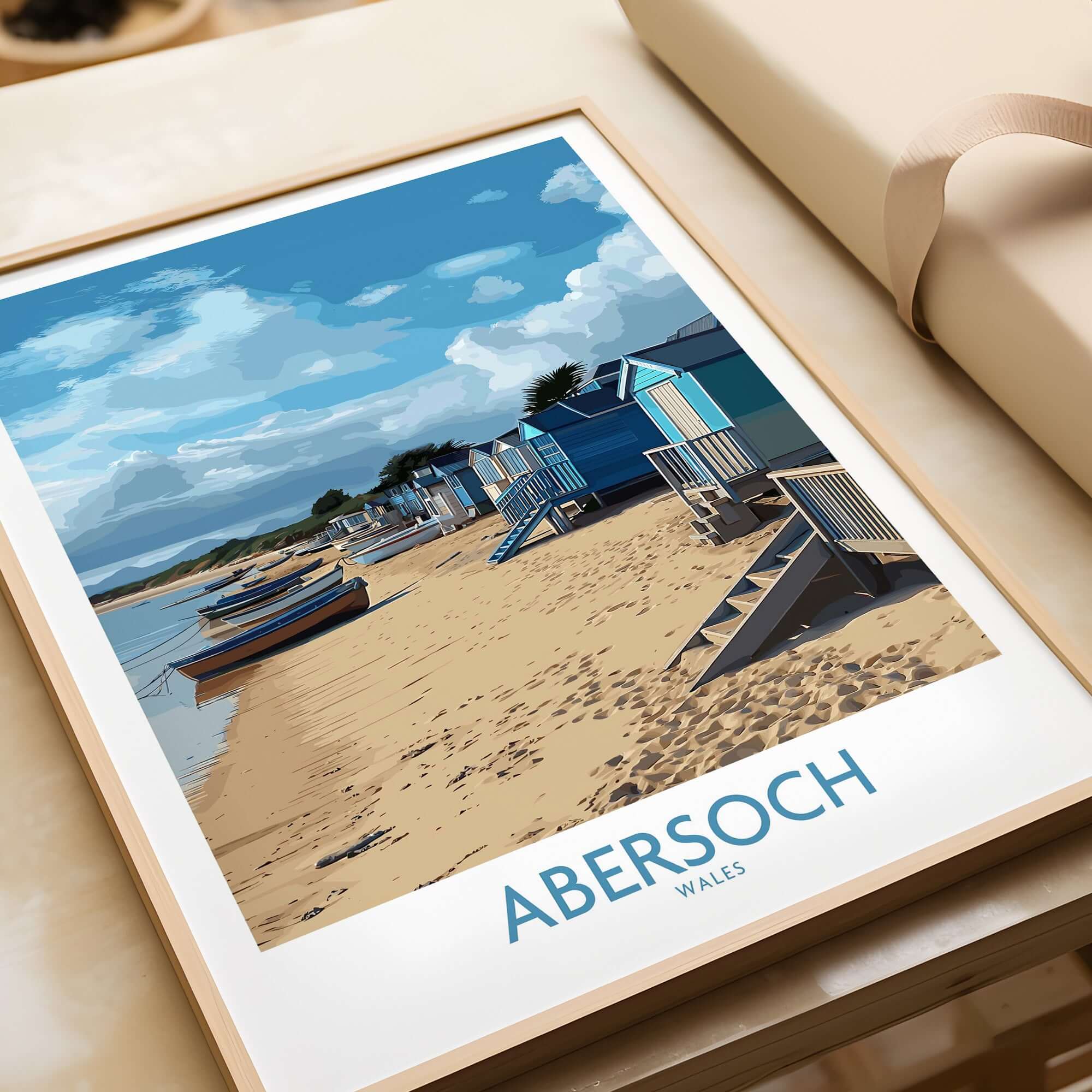 Abersoch Wales Beach Huts Art Print | Coastal Boats Wall Decor Poster featuring colorful beach huts and boats on sandy shore.