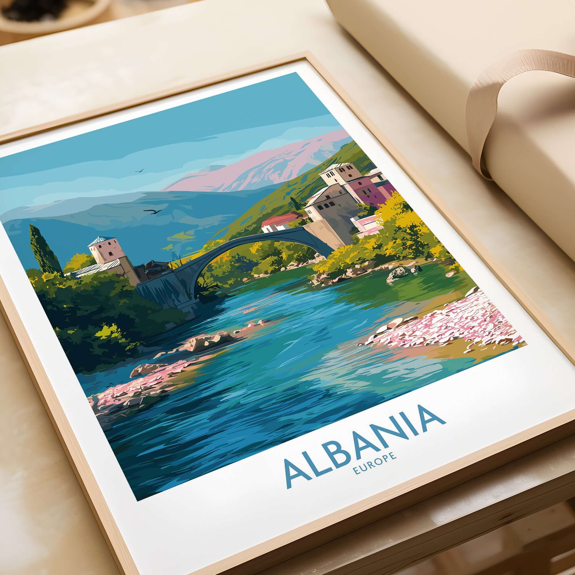 Albania Historic Stone Bridge Art Print | Mountain River Landscape Poster displayed in a modern frame on a table