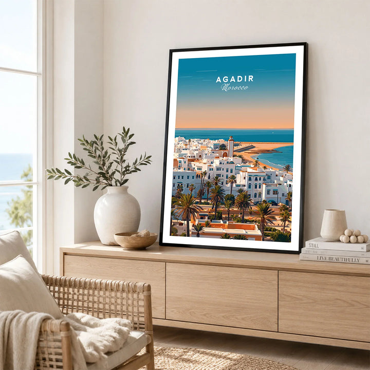 Agadir Travel Poster – City Skyline in a black frame displayed on an oak sideboard in a bright coastal living room