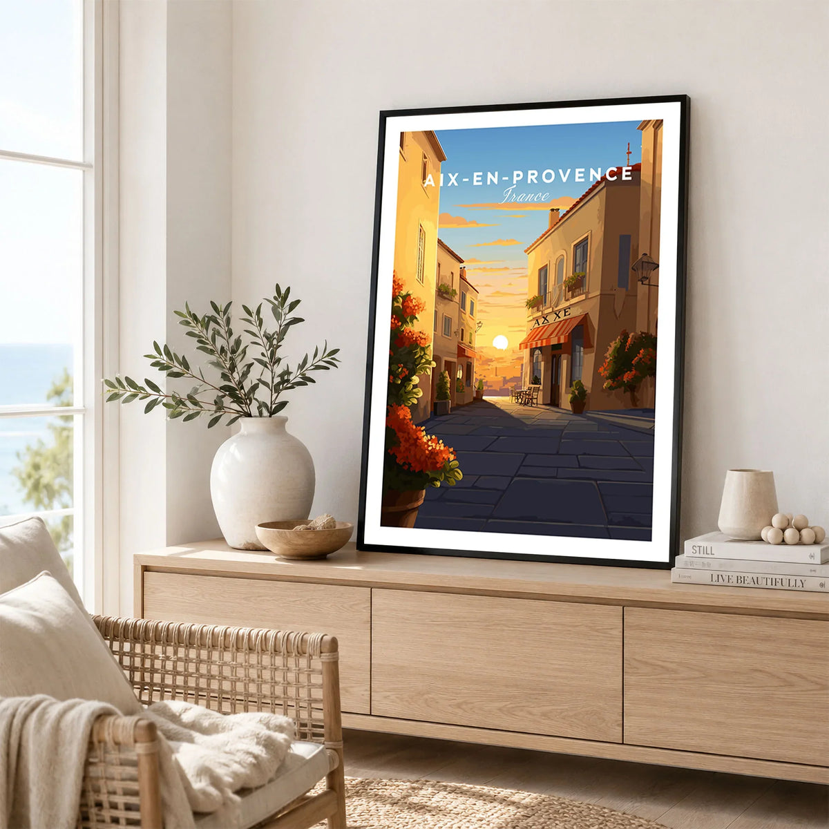 Aix-en-Provence Poster in a black frame displayed on an oak sideboard in a bright coastal living room