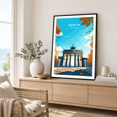 Berlin Poster Blue Sky in a black frame displayed on an oak sideboard in a bright coastal living room