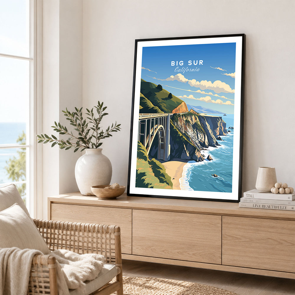 Big Sur Print in a black frame displayed on an oak sideboard in a bright coastal living room