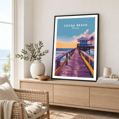 Cocoa Beach Boardwalk Print - Florida Sunset Wall Art in a black frame displayed on an oak sideboard in a bright coastal living room