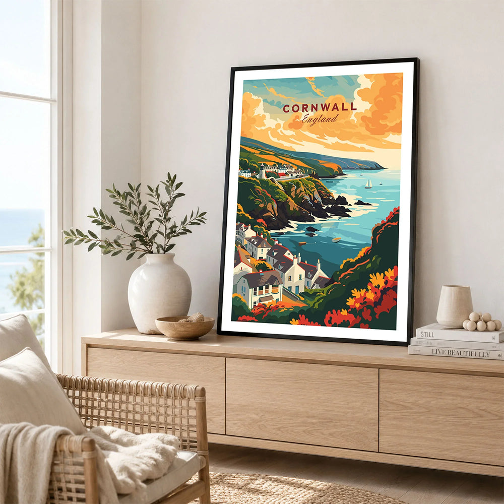 Cornwall Travel Print in a black frame displayed on an oak sideboard in a bright coastal living room