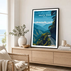 Death Road Yungas Adventure Scenic Print | Bolivian Travel Wall Decor in a black frame displayed on an oak sideboard in a bright coastal living room