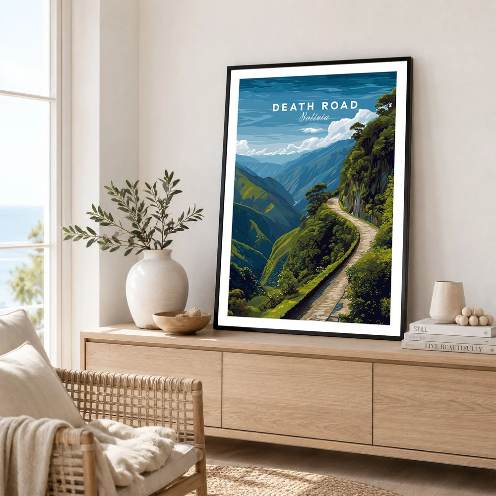 Death Road Andes Print | Yungas Road Poster in a black frame displayed on an oak sideboard in a bright coastal living room