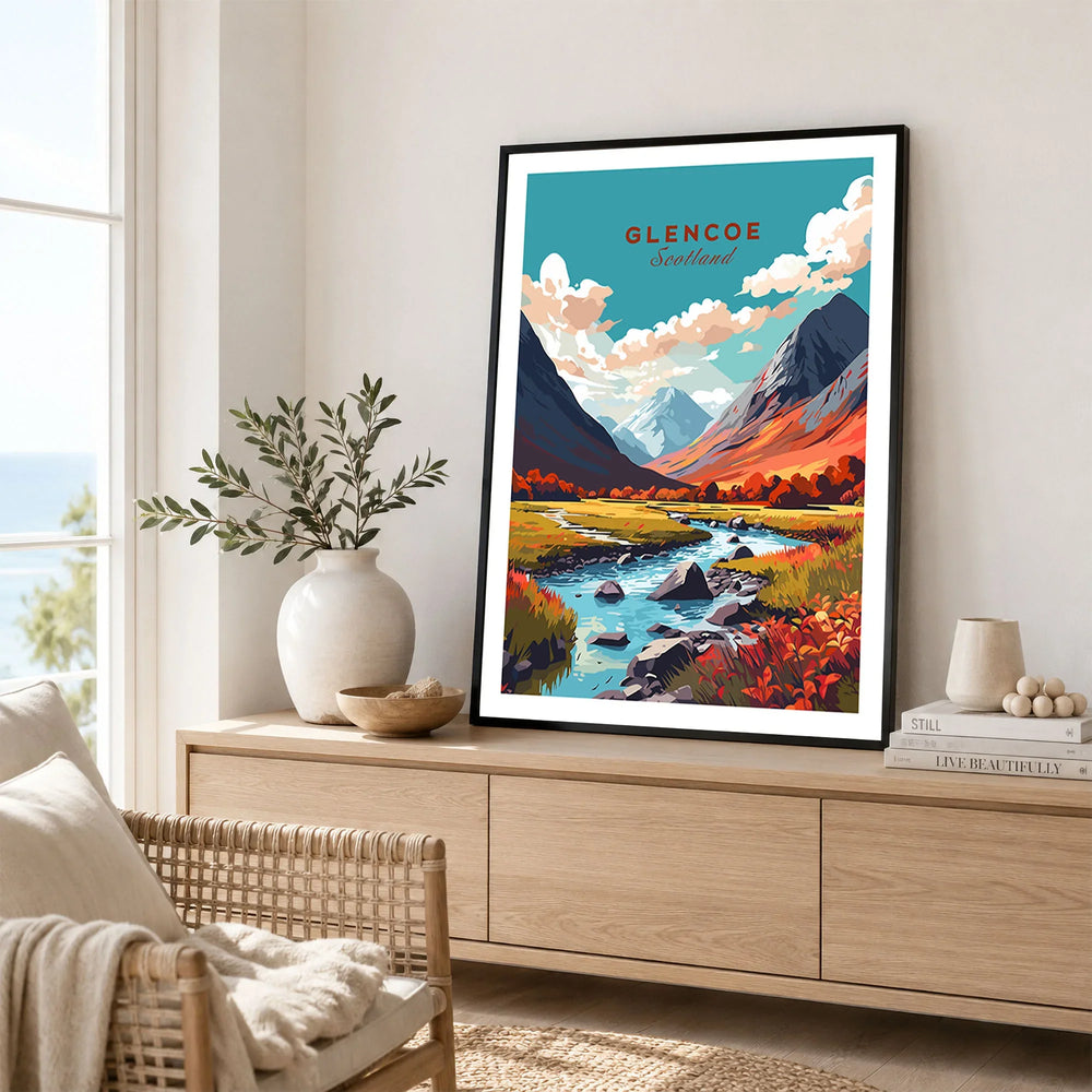 Glencoe Poster Print in a black frame displayed on an oak sideboard in a bright coastal living room