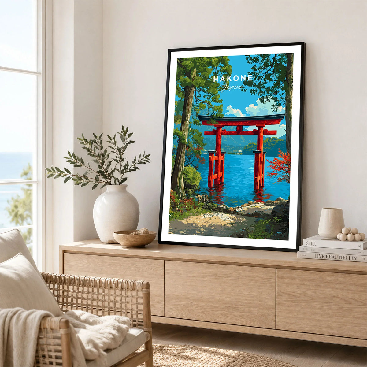 Hakone Japan Lake Ashi Torii Gate Poster - Floating Gate Wall Art in a black frame displayed on an oak sideboard in a bright coastal living room