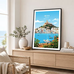 Ibiza Print in a black frame displayed on an oak sideboard in a bright coastal living room