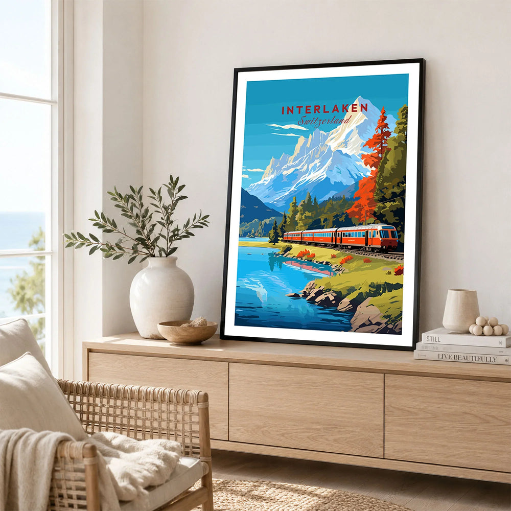 Interlaken Print Switzerland in a black frame displayed on an oak sideboard in a bright coastal living room