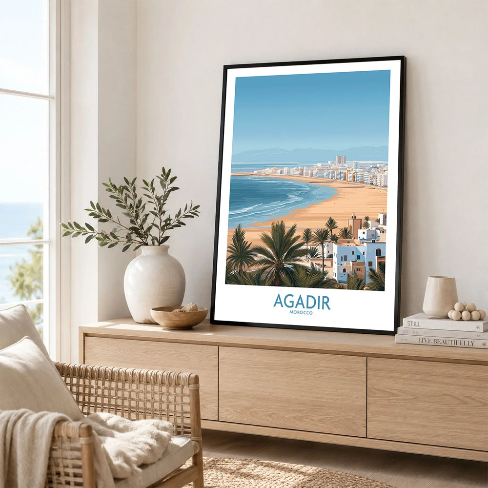 Agadir Morocco Print – Panoramic Beach and Palm Tree Wall Decor in a black frame displayed on an oak sideboard in a bright coastal living room