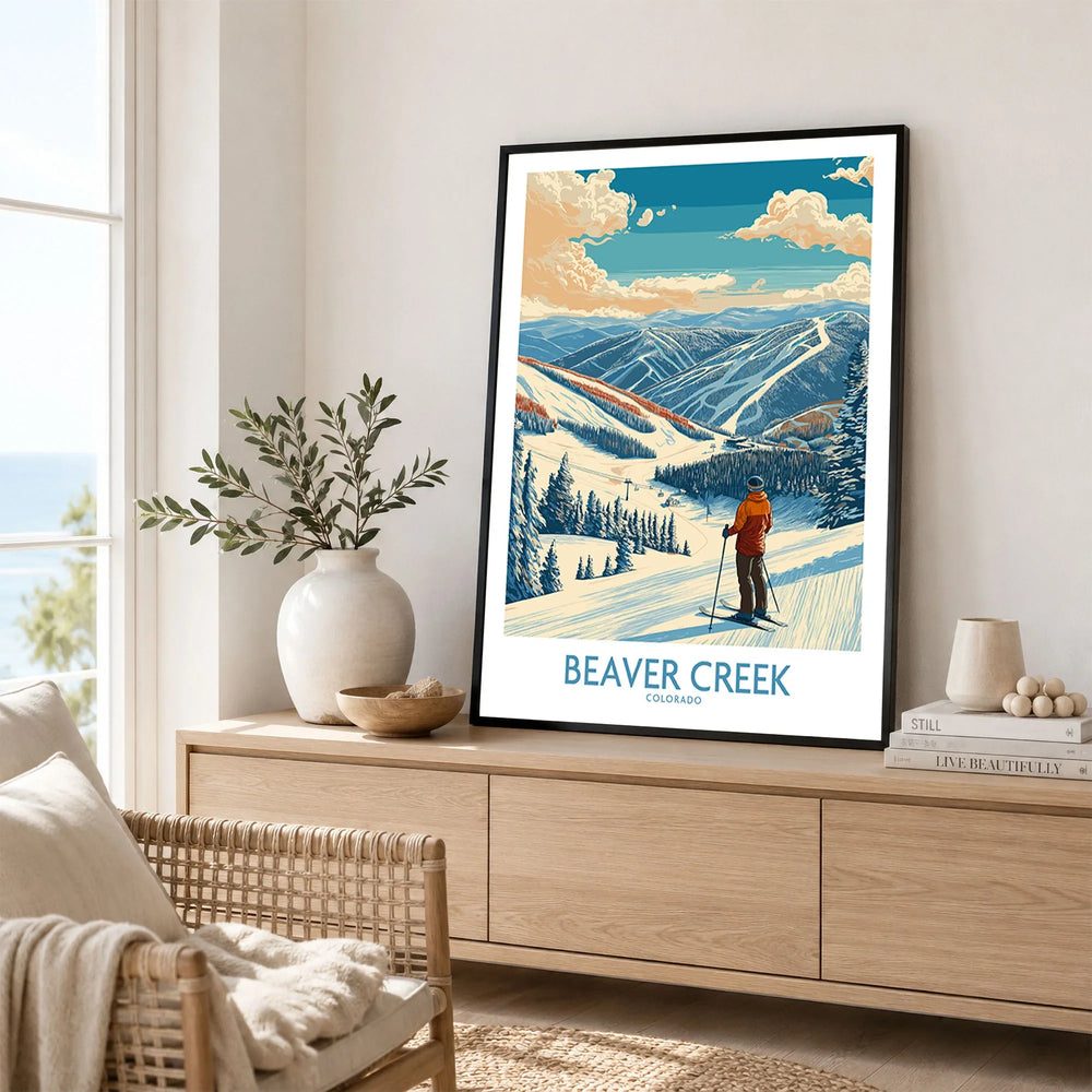 Beaver Creek Colorado Skier Landscape Poster - Colorado Winter Travel Decor in a black frame displayed on an oak sideboard in a bright coastal living room