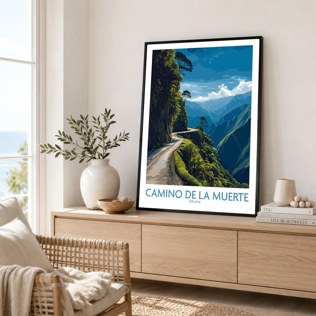 Camino de la Muerte Bolivia Cliff Road Wall Art — the Yungas cliff road curving along a jungle mountainside above the Bolivian Andes, shown as framed artwork living room lifestyle setting