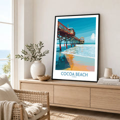 Cocoa Beach Pier Poster - Florida Beach Travel Decor in a black frame displayed on an oak sideboard in a bright coastal living room