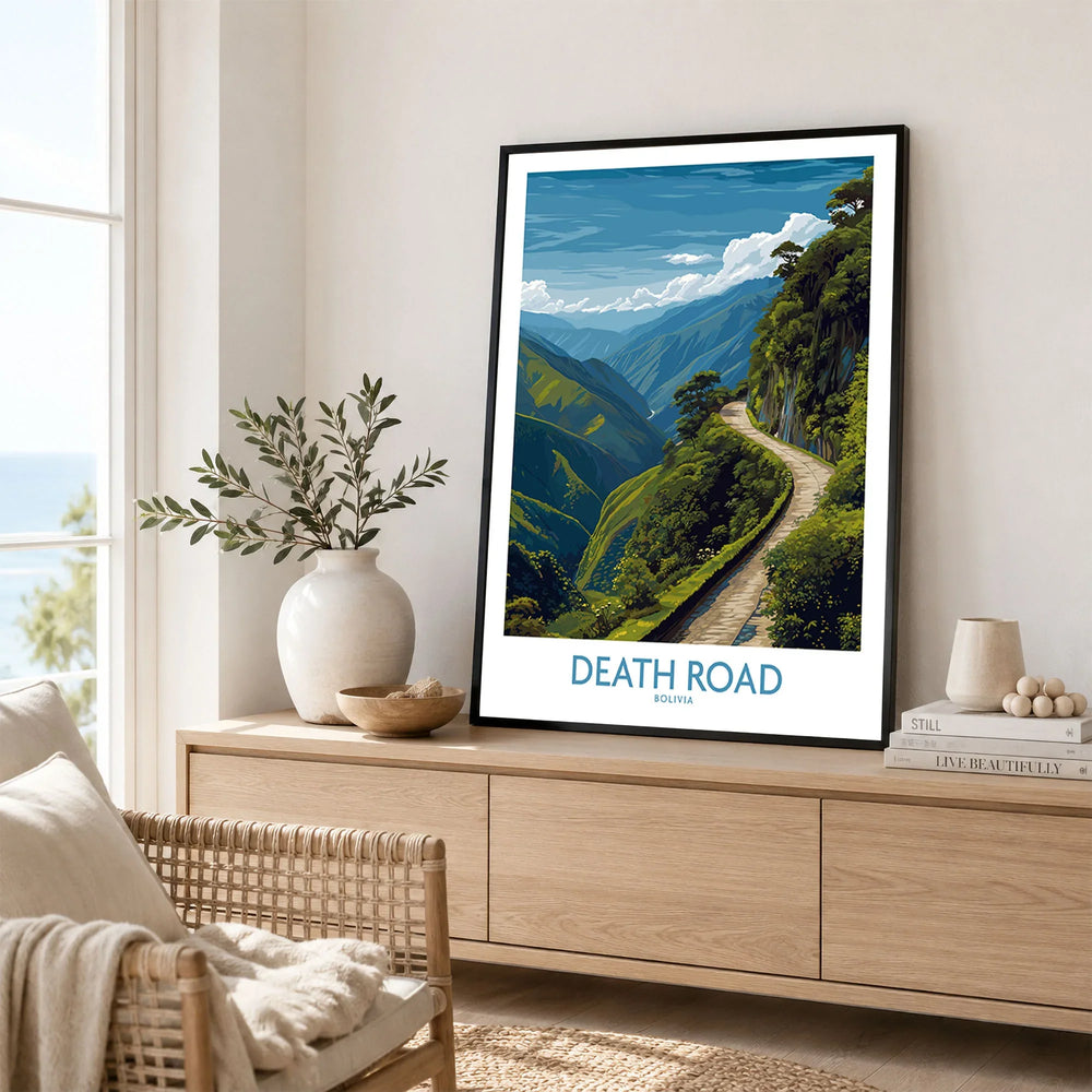 Death Road Bolivia Art Print | Yungas Road Poster in a black frame displayed on an oak sideboard in a bright coastal living room