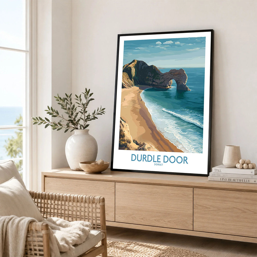 Durdle Door Art Print Dorset Wall Art in a black frame displayed on an oak sideboard in a bright coastal living room