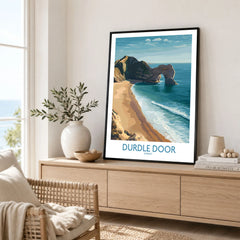 Durdle Door Art Print Dorset Wall Art in a black frame displayed on an oak sideboard in a bright coastal living room