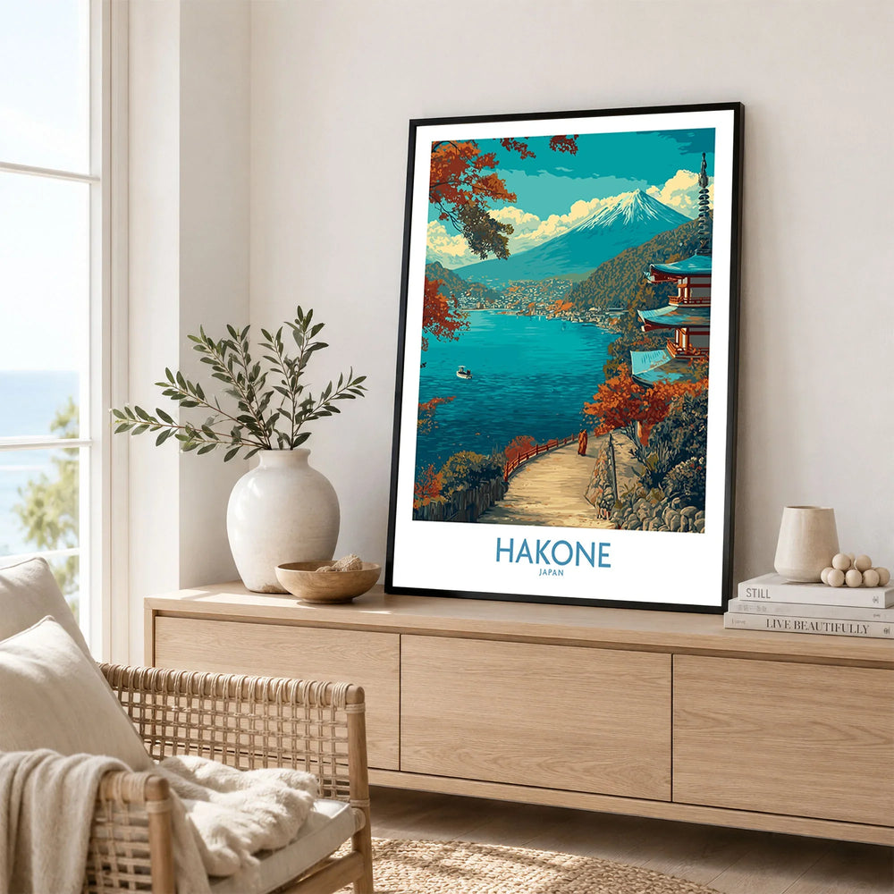 Hakone Japan Lakeside Temple Wall Art - Japanese Nature Travel Decor in a black frame displayed on an oak sideboard in a bright coastal living room