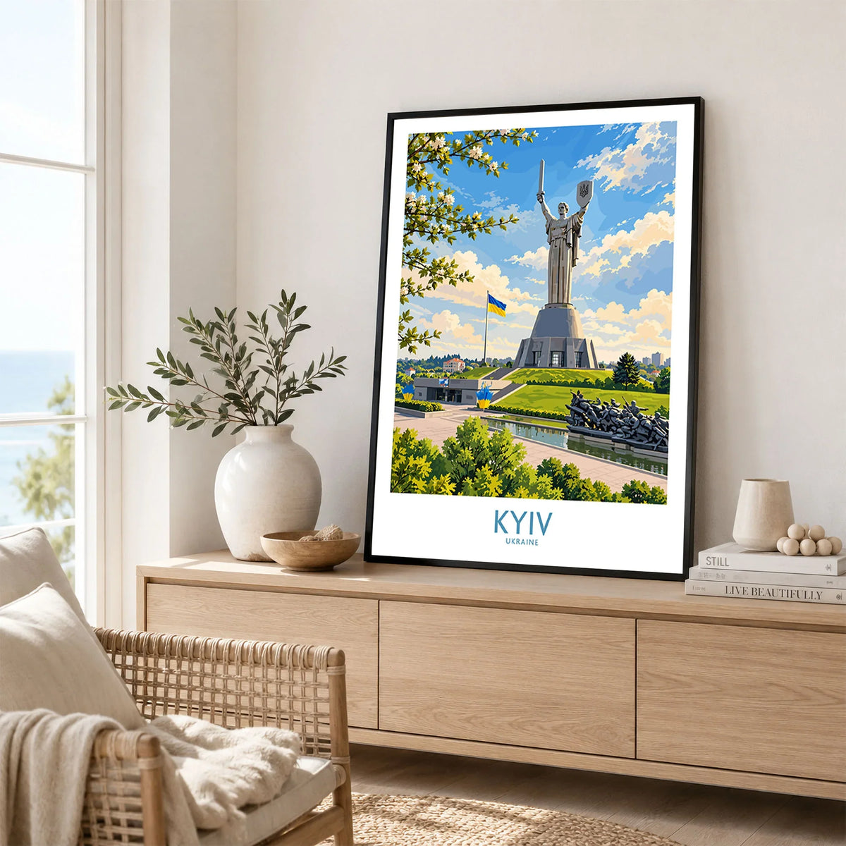 Kyiv Ukraine Spring Blossom Wall Art — the Motherland Monument under spring blossom with the Ukrainian flag flying, shown as framed artwork living room lifestyle setting