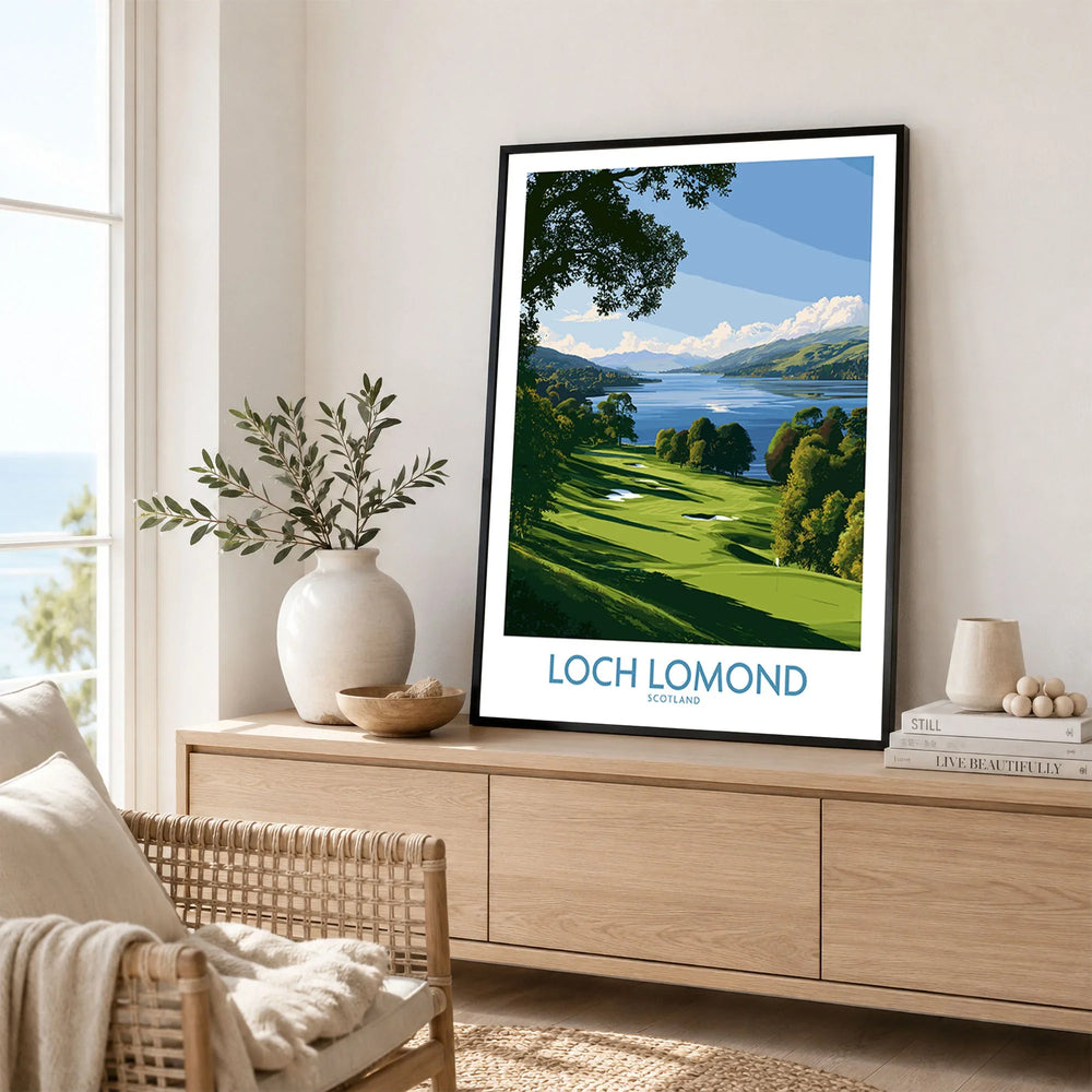 Loch Lomond Scotland Lochside Meadow Wall Art — a sunlit grassy shoreline running down to Loch Lomond under old oaks, shown as framed artwork living room lifestyle setting