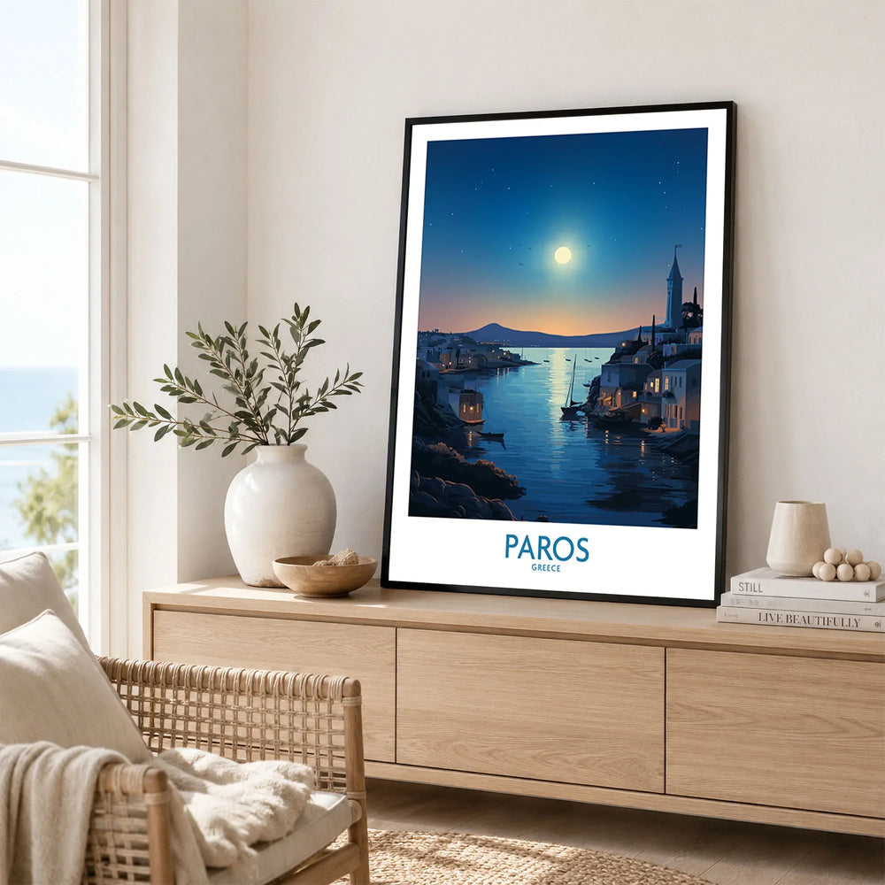 Paros Poster Greece in a black frame displayed on an oak sideboard in a bright coastal living room