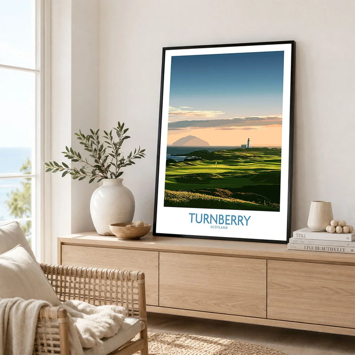 Turnberry Scotland Ayrshire Dusk Wall Art — Ailsa Craig and the white lighthouse across rolling coastal turf at dusk, shown as framed artwork living room lifestyle setting