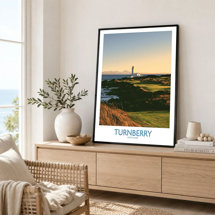 Turnberry Scotland Rocky Shore Wall Art — the Turnberry lighthouse above a rocky shore with the Arran hills beyond, shown as framed artwork living room lifestyle setting